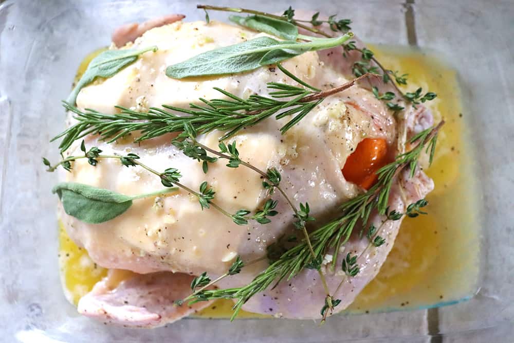Whole roasted chicken with rosemary, thyme, and sage