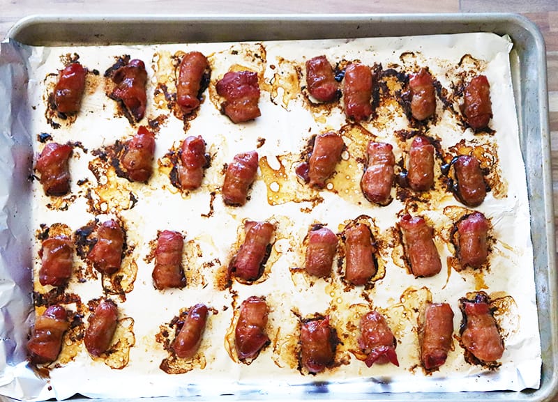 bacon wrapped lil smokies on a foil-lined baking sheet