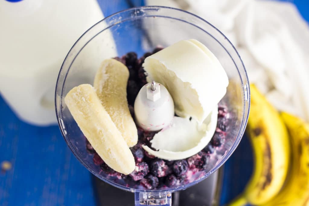 Food processor with bananas and blueberries. 