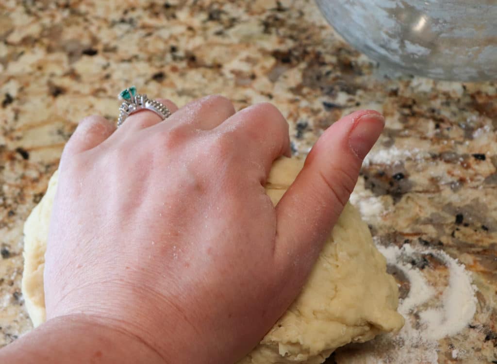Knead pizza dough for 4 minutes